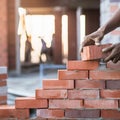 Bricklayer building wall with neatly aligned bricks, indicating a bustling environment. Royalty Free Stock Photo