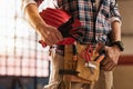 Bricklayer holding construction tools