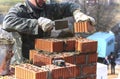 A bricklayer lays bricks to make a wall. Royalty Free Stock Photo