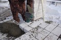 A bricklayer levels bricks in cement, makes a concrete wall, builds a shop. Royalty Free Stock Photo