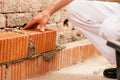 Bricklayer Making Wall With Brick And Grout