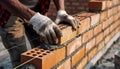 Bricklayer meticulously constructing a brick wall with precision and care Royalty Free Stock Photo