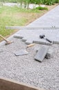 Bricklayer places concrete paving stone blocks for building up a Royalty Free Stock Photo