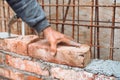 Details of worker, bricklayer placing and adjusting bricks. Professional construction worker building exterior walls Royalty Free Stock Photo