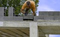 Bricklayer putting down another row of bricks in site Royalty Free Stock Photo