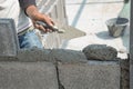 Bricklayer putting down another row of bricks in site Royalty Free Stock Photo