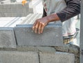 Bricklayer putting down another row of bricks in site Royalty Free Stock Photo