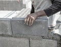 Bricklayer putting down another row of bricks in site Royalty Free Stock Photo