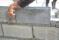 Bricklayer putting down another row of bricks in site