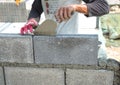 Bricklayer putting down another row of bricks in site Royalty Free Stock Photo