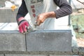 Bricklayer putting down another row of bricks in site Royalty Free Stock Photo