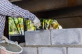 Bricklayer putting down another row of bricks in site. Royalty Free Stock Photo