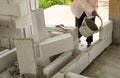 Bricklayer use concrete bucket with liquid cement making coner beads in house site building