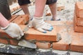 Bricklayer Using a Trowel to Lay New Red Brick House Wall Outdoor. Bricklaying Basics Masonry Techniques