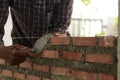 Bricklayer worker installing brick masonry