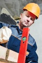 Bricklayer at work with level and trowel Royalty Free Stock Photo