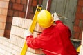 Bricklayer at work with red brick Royalty Free Stock Photo