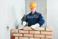 Bricklayer at work with red brick Royalty Free Stock Photo