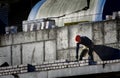 A bricklayer worker erects a wall on the construction of a multi-storey building Royalty Free Stock Photo