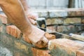 Bricklayer worker installing brick masonry on exterior wall. Professional construction worker laying bricks. Bricklayer worker Royalty Free Stock Photo