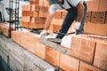 Bricklayer worker installing brick masonry on exterior wall with trowel putty knife Royalty Free Stock Photo