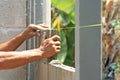 Bricklayer worker installing cement blocks wall