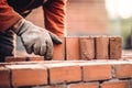 bricklayer working on brick wall at construction site