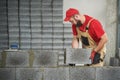 Bricklayer working with ceramsite concrete blocks. Walling