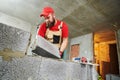 Bricklayer working with ceramsite concrete blocks. Walling Royalty Free Stock Photo