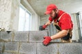 Bricklayer working with ceramsite concrete blocks. Walling