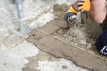 Bricklayer working with mud bricks for building a wall.