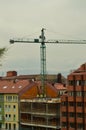 Bricklayers, Carpenters And Crane Operators Performing Their Work In A Construction Site. Architecture, Works And Services, Crafts