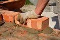 Bricklayers hands in masonry gloves bricklaying house wall. Bricklaying, Masonry, Brickwork close up