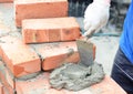 Bricklayers hands in masonry gloves bricklaying new house wall. Bricklaying house wall Royalty Free Stock Photo