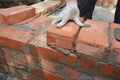 Bricklayers hands in masonry gloves bricklaying new house wall