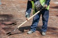 Bricklayers scraping the waterproofing off a roof with a trowel to prevent dampness in the buildings Royalty Free Stock Photo