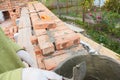 Bricklaying, Brickwork. Bricklayer Worker Installing Red Bricks and Caulking Brick Masonry Joints Exterior Wall with Trowel putty Royalty Free Stock Photo