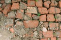 Bricklaying from broken red brick with sprouted grass