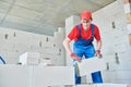 Bricklayer builder working with autoclaved aerated concrete blocks. Walling