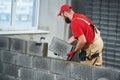 Bricklayer builder working with ceramsite concrete blocks. Walling Royalty Free Stock Photo