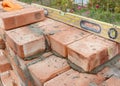 Bricklaying on House Construction Site with Spirit Level.