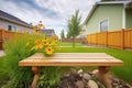 bricklined prairie flowerbed with wooden bench beside