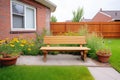 bricklined prairie flowerbed with wooden bench beside