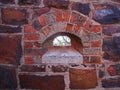 BRICKS AROUND A FORT WINDOW OPENING IN STONE WALL Royalty Free Stock Photo