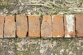 Bricks on ground. Old bricks lie in row. Stones are stacked together Royalty Free Stock Photo