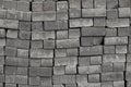 Bricks paving stones on pallets, background texture close-up Cobblestones paving roads, materials for construction