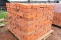 The bricks are stacked on wooden pallets and prepared for sale. Clay brick is an ecological building material. Royalty Free Stock Photo