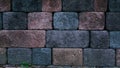 Bricks of various dark colors piled up