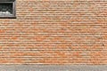 Textured background of a red brick wall with a window. Royalty Free Stock Photo