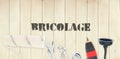 Bricolage against diy tools on wooden background Royalty Free Stock Photo